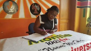 Nana Oye Lithur signing a petition for President Mahama to pardon the contemnors.