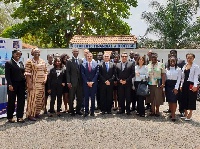 The ambassador (5th L), some members of the community, staff and beneficiaries in a pose