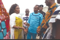 Mrs Catherine Afeku (left) in a chat with Mr Kwamena Duncan (right) and other officials.