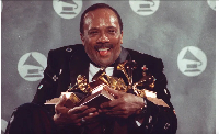 Quincy Jones cradles his Grammy awards, including the album of the year award