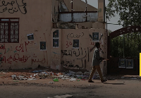 Someone is seen walking  outside a hospital in Khartoum, Sudan, Tuesday, Sept. 27, 2022