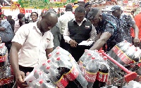 Some officials of the GRA Customs Division checking products at the Achimota Retail Centre in Accra