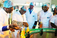 Mr Kwakye Darfour (second left) affixing a tax stamp on a product at the Fedex Enterprise