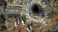 An aerial view of a mine shaft where an estimated 4,000 illegal miners are in a disused mine