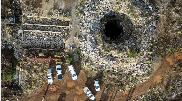 An aerial view of a mine shaft where an estimated 4,000 illegal miners are in a disused mine