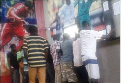 People taking bets in a sports betting company in Ghana