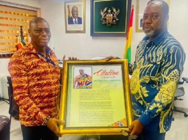 Prof. Kingsley Nyarko (left) presenting a citation to NAPO