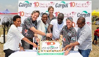 Some Cargill executives cutting the cake to mark a decade of innovation and sustainability in Ghana