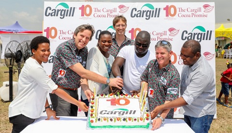 Some Cargill executives cutting the cake to mark a decade of innovation and sustainability in Ghana