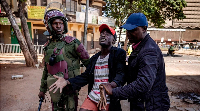 Police officers arrest a protester following clashes with opposition supporters in Nairobi, Kenya