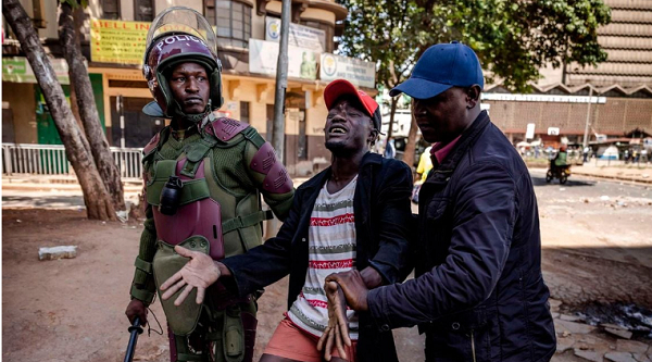 Police officers arrest a protester following clashes with opposition supporters in Nairobi, Kenya