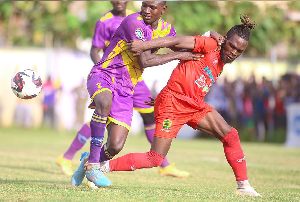 Steven Mukwala (in red) against Medeama