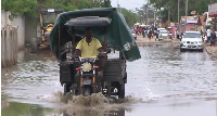 A driver is seen driving though flood