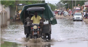A driver is seen driving though flood
