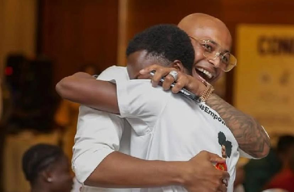 Dede Ayew (L) and Portia Boakye shared a hug at a special dinner with President Mahama
