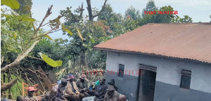 Mourners gather at the home of flood victim Gad Dushimimana in Rucyantege Village