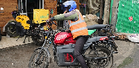 A rider sits on an electric Spiro motorcycle in Nairobi, Kenya