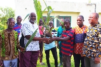 A farmer receiving his coconut seedling from Stephen Tecku