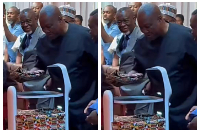 A robot handing over Ghana's National Artificial Intelligence Strategy document to President Mahama