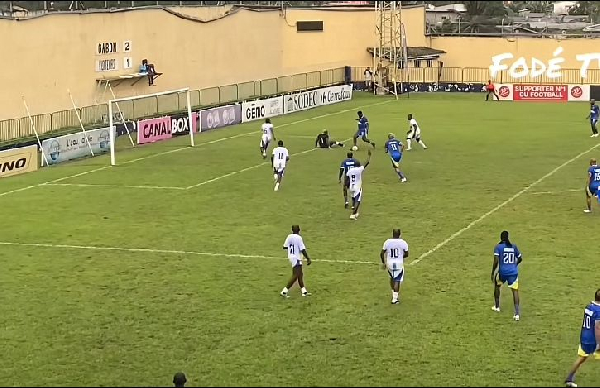 Asamoah Gyan slotting the ball into the net