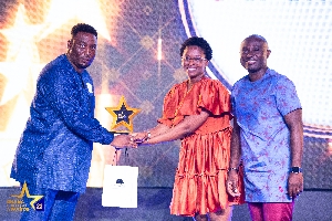 Receiving the awards on behalf of eTranzact Ghana , Yvonne Effe and Mr Paul Otu