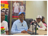 Jacob Osei Yeboah (M) addressing members of the political group at a press conference