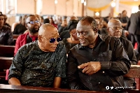 Alhaji Boniface and Alan having a chat at a funeral
