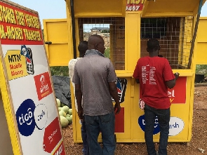Customers at a Mobile Money vendor's shop