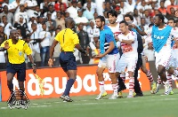 Referee Joseph Lamptey being attacked by players of Zamalek after a controversial decision in a CAF