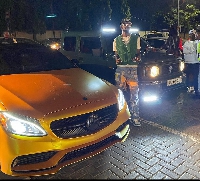 Rapper Black Sherif poses with his cars