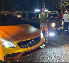 Rapper Black Sherif poses with his cars