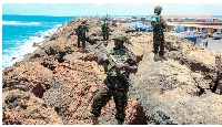Kenya Defence Forces soldiers serving under the AU Mission in Somalia guard Kismayu Sea Port