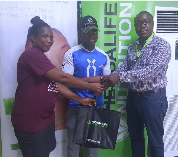 A representative of Bling Body Gym receiving the prize