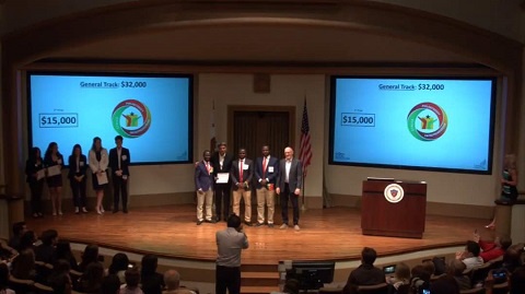 The three students in a group photograph with the judges