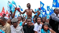 Supporters cheer during a campaign rally at Sainte Therese in the Ndjili District of Kinshasa