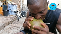 Solomon demonstrates how easily he can peel off a coconut with his bare teeth