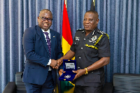 Seidu Issifu (L) exchanging pleasantries with the IGP Christian Tetteh Yohuno (R)
