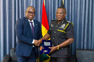 Seidu Issifu (L) exchanging pleasantries with the IGP Christian Tetteh Yohuno (R)