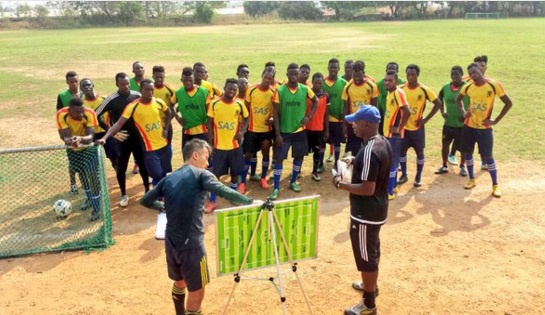 Hearts coaches Kenichi Yatsuhashi and Yaw Preko taking Hearts players through drawing board tactics