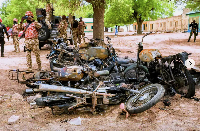 A soldier takes photos of burned motorbikes in Guyaku, northeastern Nigeria, Monday, April 27, 2026