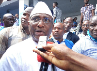 Sidya Touré speaks on phone outside his Conakry home