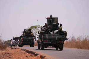 Nigerian soldiers patrol near a school in Kuriga where students were kidnapped on March 7