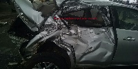 The damaged saloon car at the accident scene