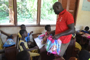 Airtel Employee distributing the gift packs to the pupils