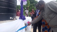 Michael Alabi and others cutting the tape to inaugurate  water project for  NJUASCO