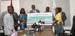 Prof. Adanu [middle] presenting the dummy cheque to Ms Darko -Opoku [fourth from left]