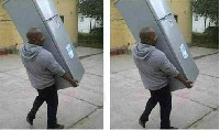 The man carrying the fridge away