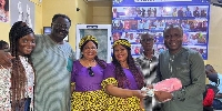 The twin US-based donors with their family presenting the money to Ibrahim Oppong Kwarteng