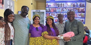 The twin US-based donors with their family presenting the money to Ibrahim Oppong Kwarteng