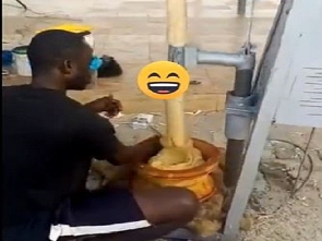 A photo of the man and fufu pounding machine